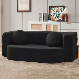 Schwarzes AirBloom Sofa mit zwei runden Kissen in einem Aufstellbeispiel